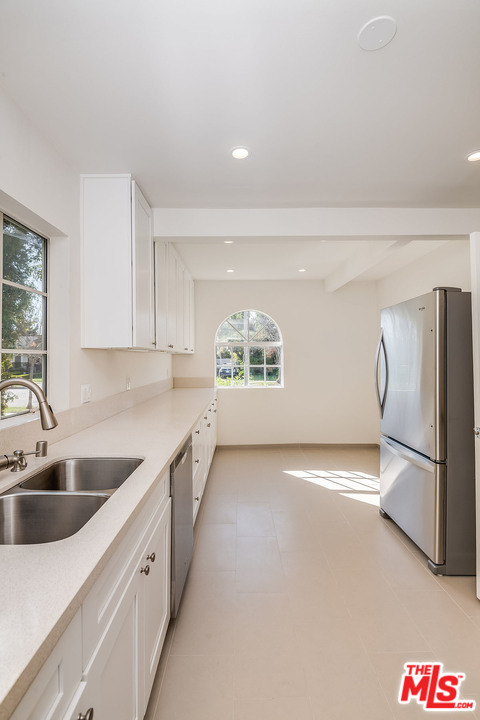 148 Le Doux Road Beverly Hills, CA 90211 - Photo 5 of 22 a kitchen with a sink and refrigerator