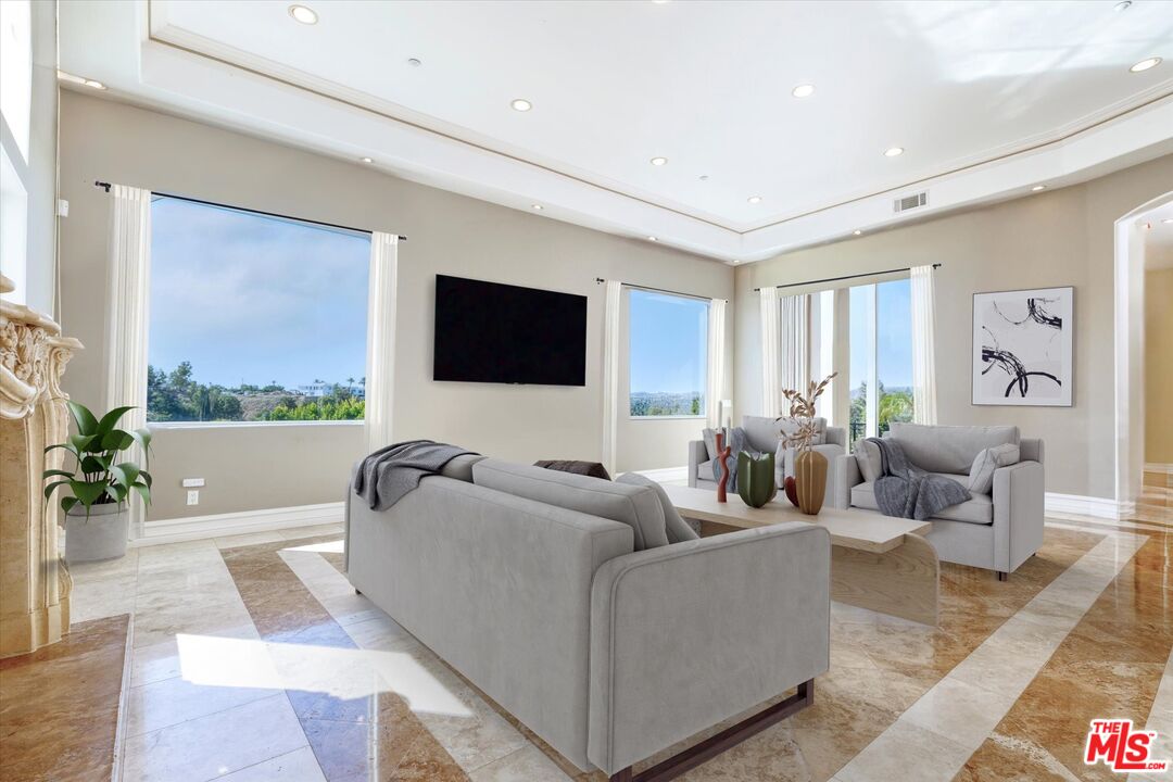 22470 Sueno Road Woodland Hills, CA 91364 - Photo 4 of 18 a living room with furniture and a flat screen tv