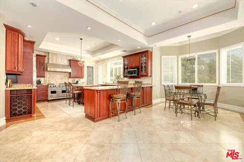 a kitchen with stainless steel appliances kitchen island granite countertop a sink and cabinets