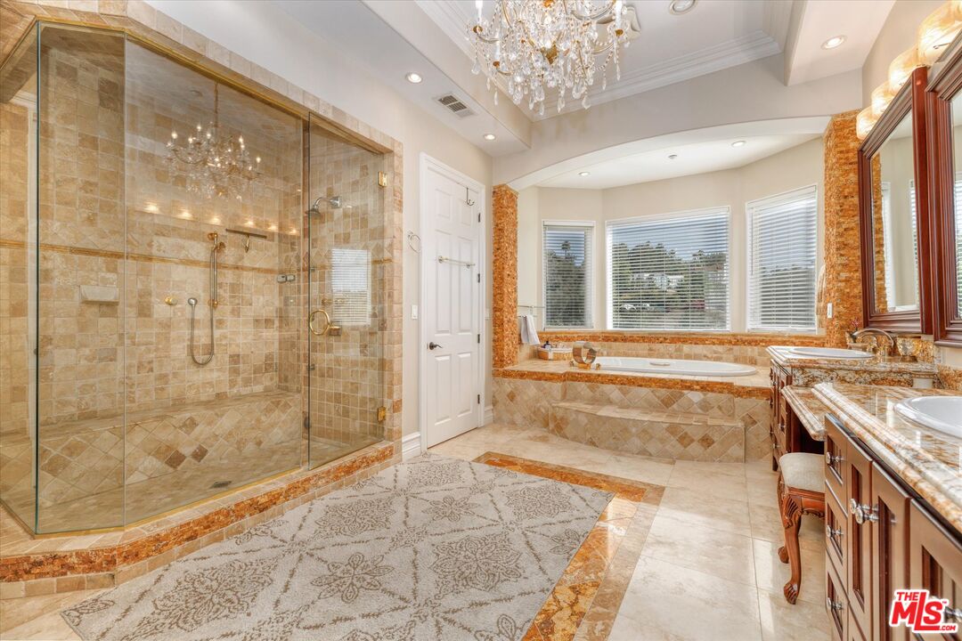 22470 Sueno Road Woodland Hills, CA 91364 - Photo 9 of 18 a spacious bathroom with a tub shower and windows