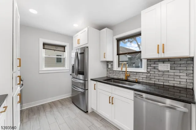 a kitchen with a sink stove and refrigerator