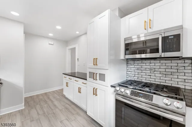 a kitchen with stainless steel appliances and white cabinets