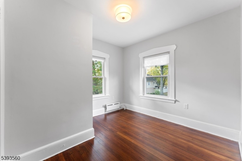 177 West Pierrepont Avenue Rutherford, NJ 07070 - Photo 25 of 27 an empty room with wooden floor and windows