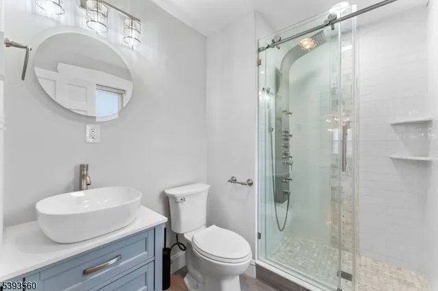 a bathroom with a toilet a sink and a mirror