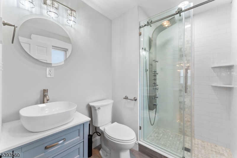 177 West Pierrepont Avenue Rutherford, NJ 07070 - Photo 8 of 27 a bathroom with a toilet a sink and a mirror