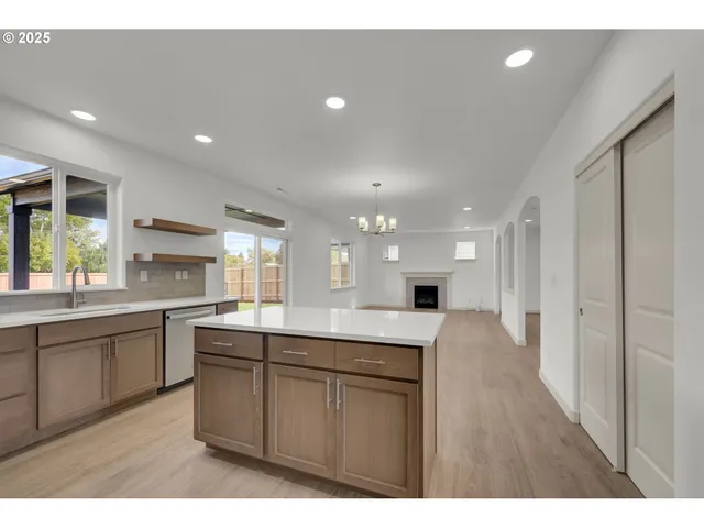 a kitchen with granite countertop a sink and cabinets