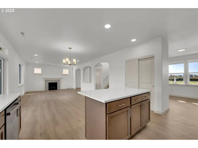 a kitchen with a sink dishwasher a stove and a refrigerator with wooden floor