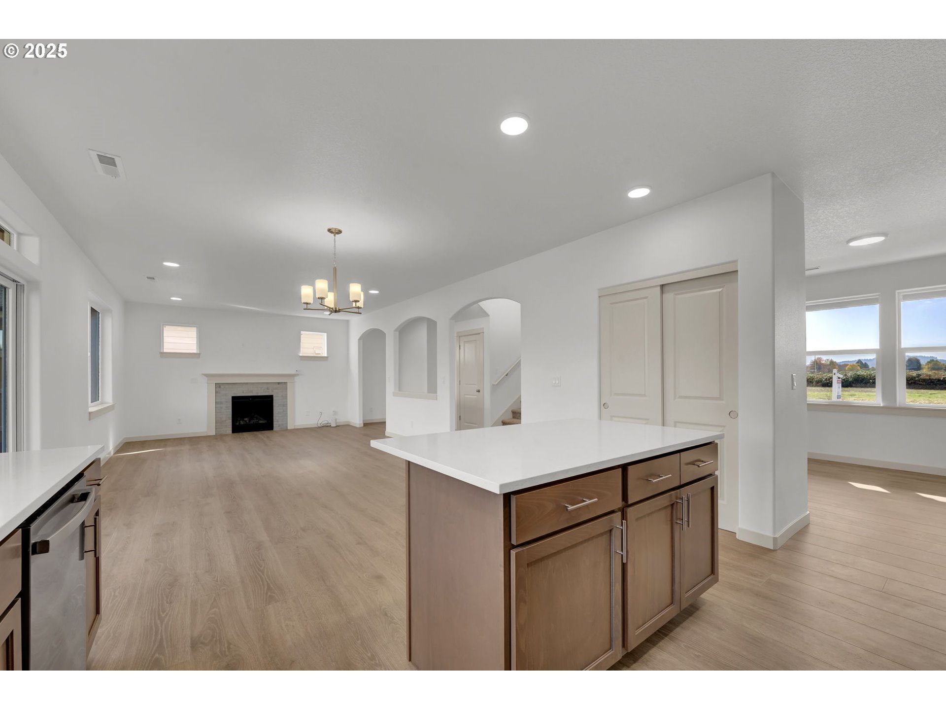 5653 Magnificence Way Eugene, OR 97402 - Photo 14 of 44 a kitchen with a sink dishwasher a stove and a refrigerator with wooden floor