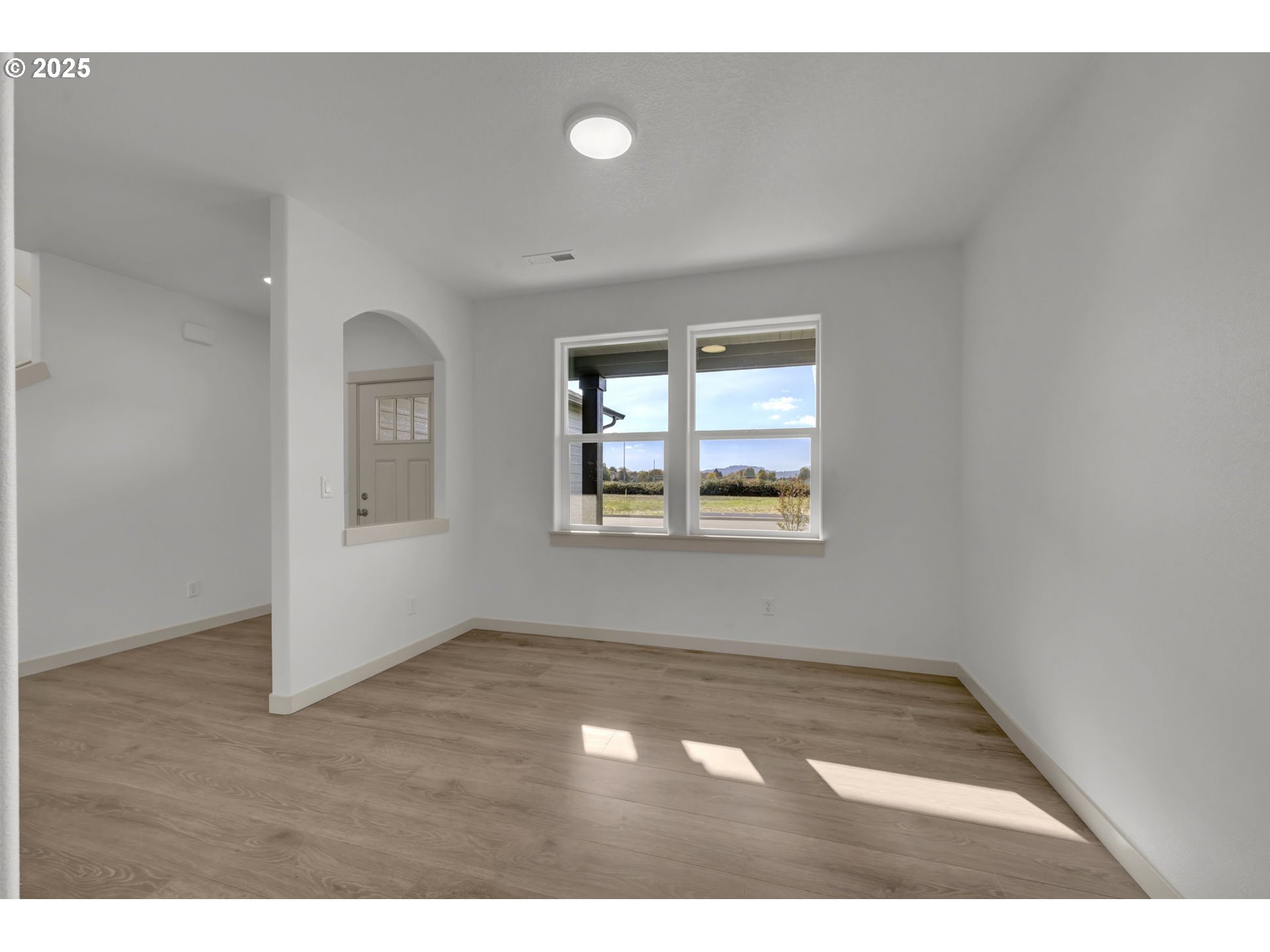 5653 Magnificence Way Eugene, OR 97402 - Photo 15 of 44 an empty room with wooden floor and windows