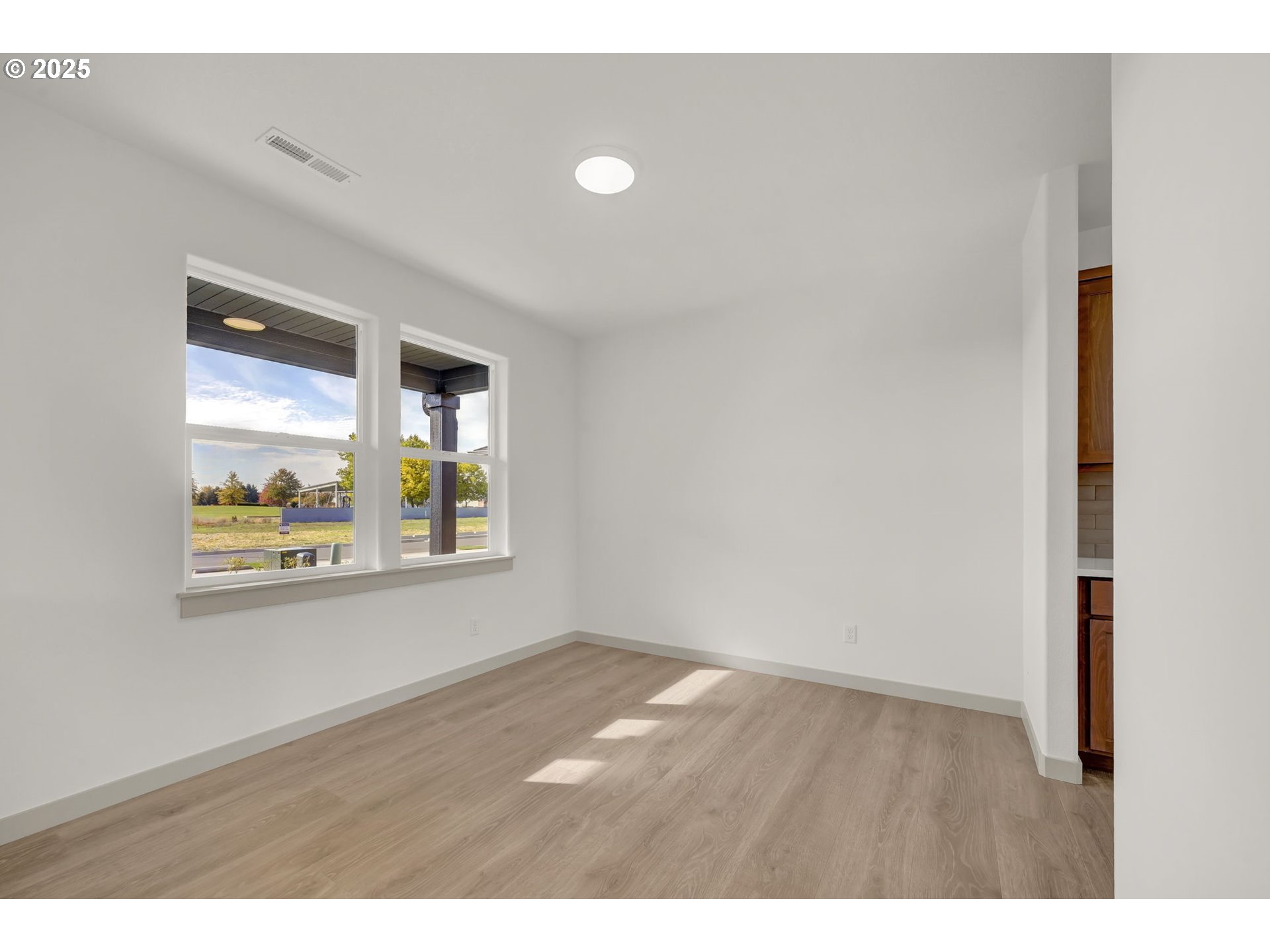 5653 Magnificence Way Eugene, OR 97402 - Photo 17 of 44 a view of an empty room with wooden floor and a window