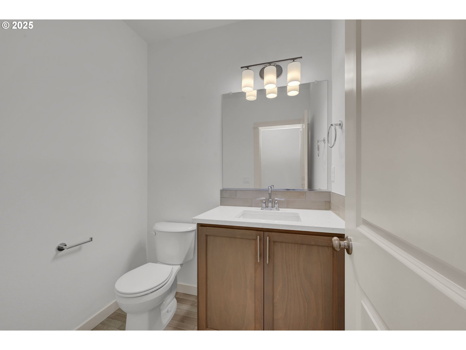 5653 Magnificence Way Eugene, OR 97402 - Photo 19 of 44 a bathroom with a granite countertop sink a toilet and a mirror