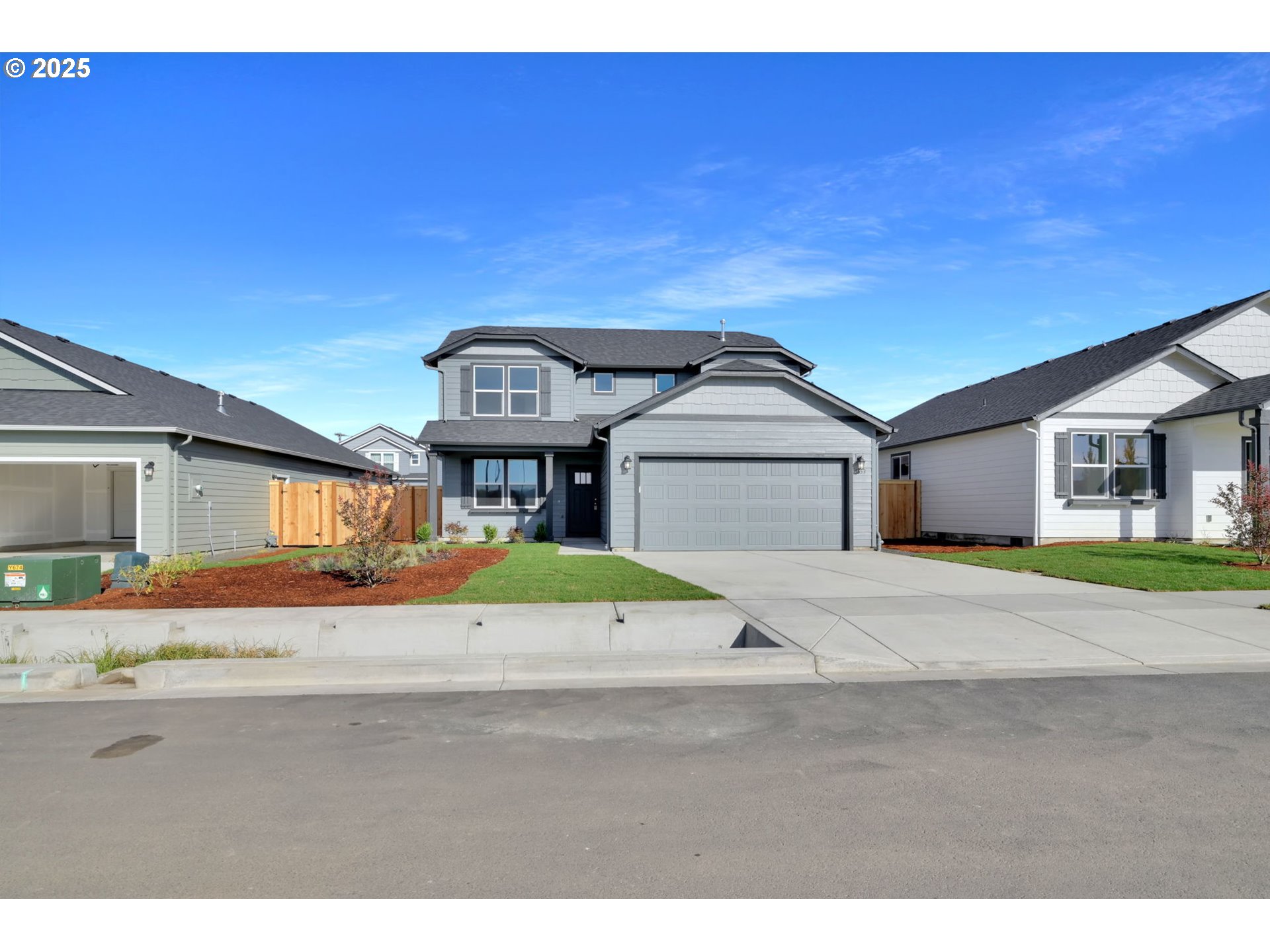 5653 Magnificence Way Eugene, OR 97402 - Photo 23 of 44 a front view of a house with a yard and garage