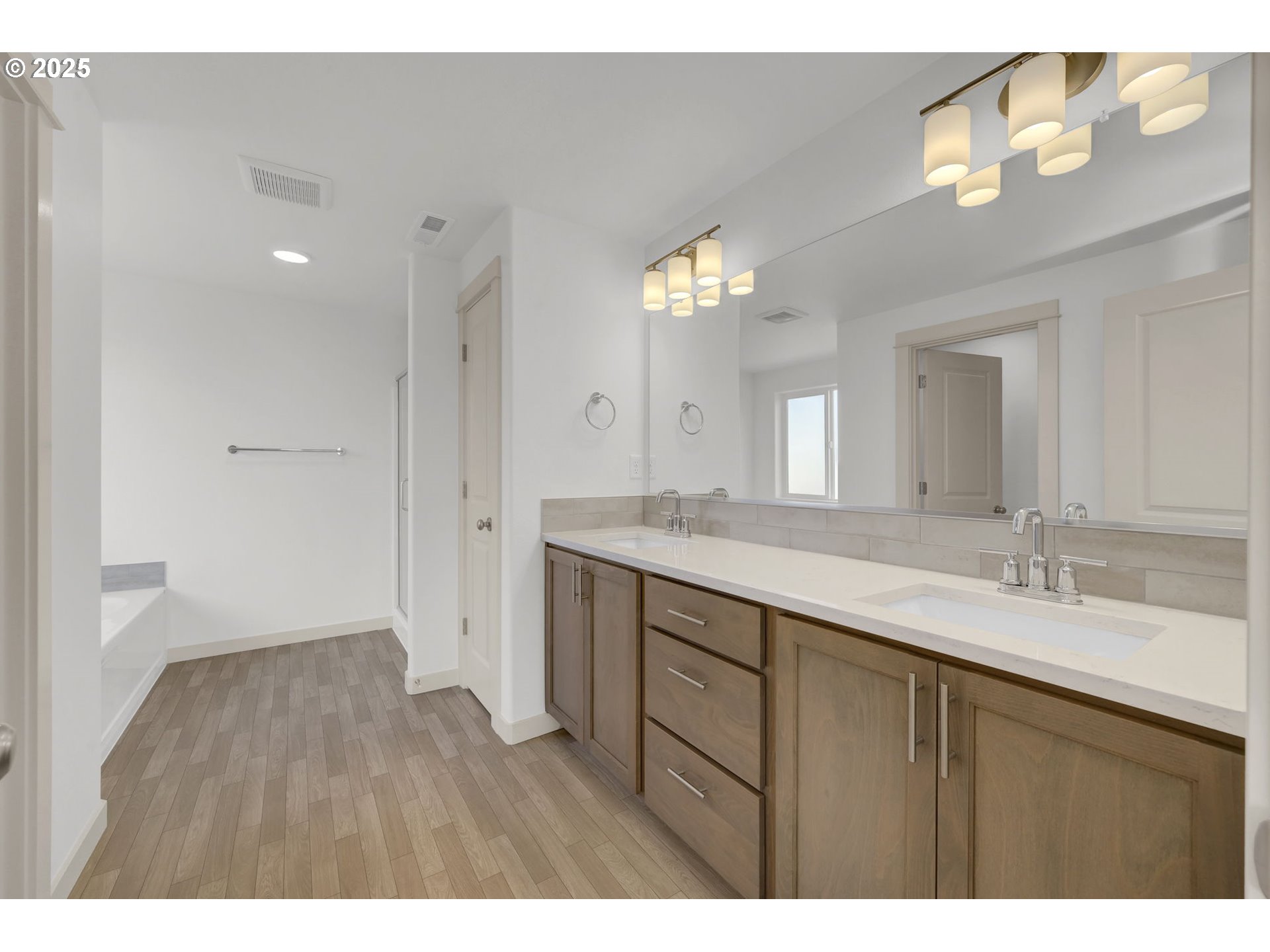 5653 Magnificence Way Eugene, OR 97402 - Photo 26 of 44 a bathroom with a double vanity sink and a mirror