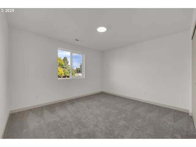 a view of an empty room and a window