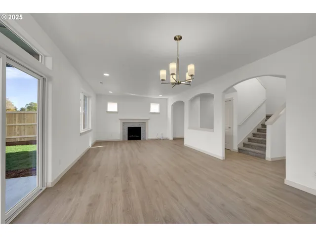 a view of an empty room and wooden floor