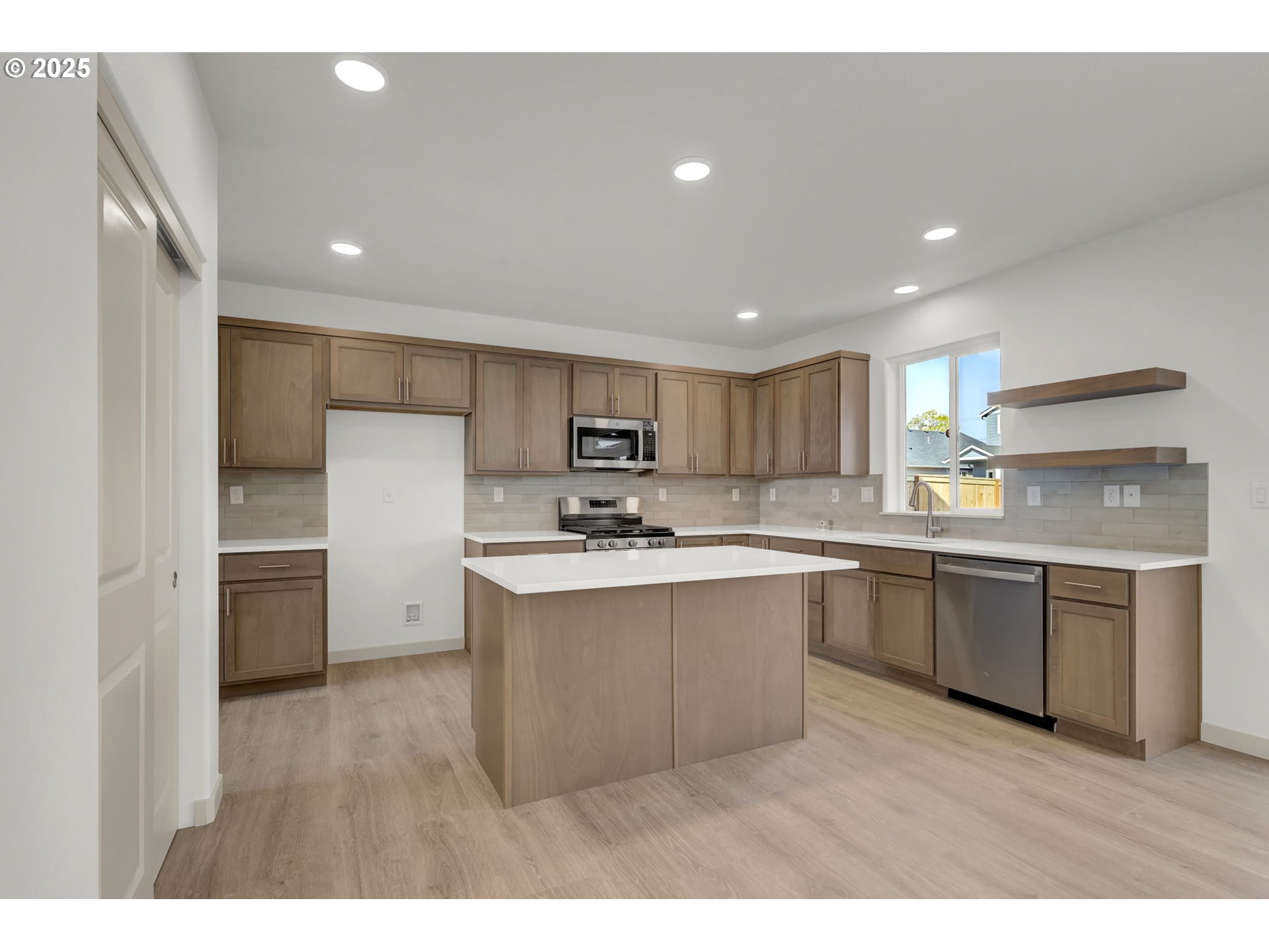 5653 Magnificence Way Eugene, OR 97402 - Photo 7 of 44 a kitchen with refrigerator and cabinets