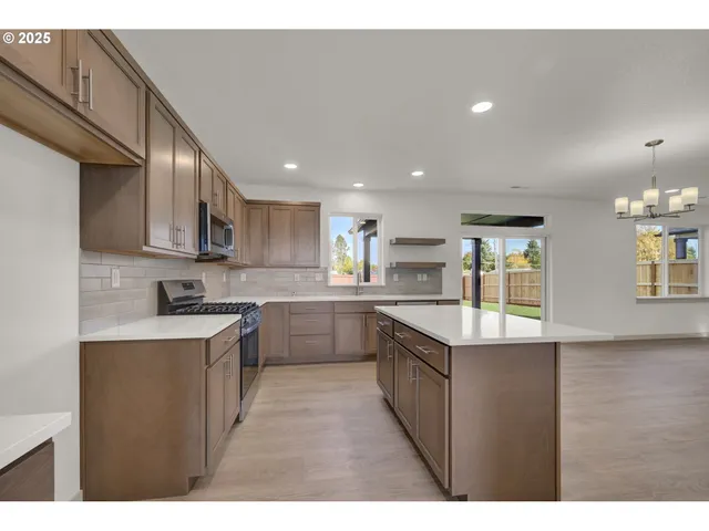 a kitchen with a sink window and cabinets