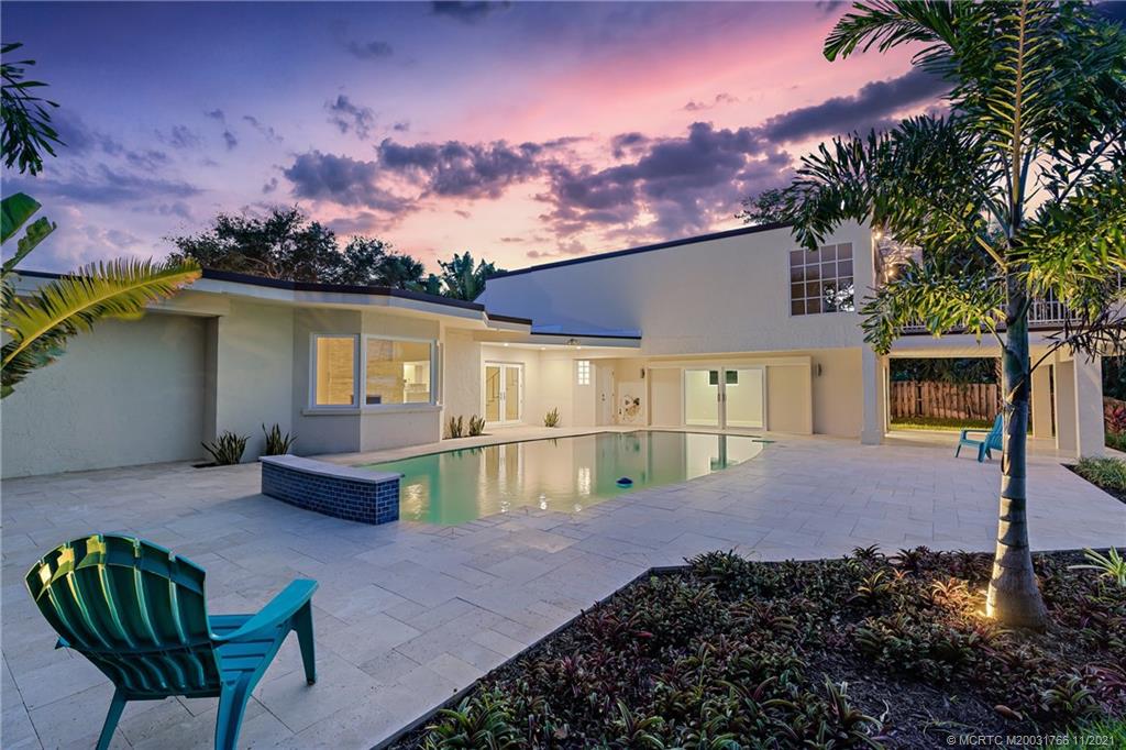 1037 Southeast Riverside Drive Stuart, FL 34996 - Photo 9 of 46 36 'x 18' pool looking back at the Casita or Cabana and surrounded by a spacious 1,900 Sq' Travertine Pool Deck and convenient covered patio living areas.