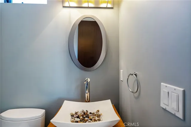 a bathroom with a toilet and a mirror