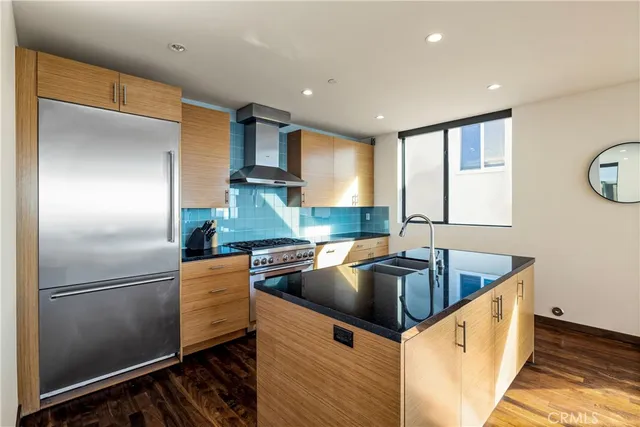 a kitchen with a refrigerator sink and stove