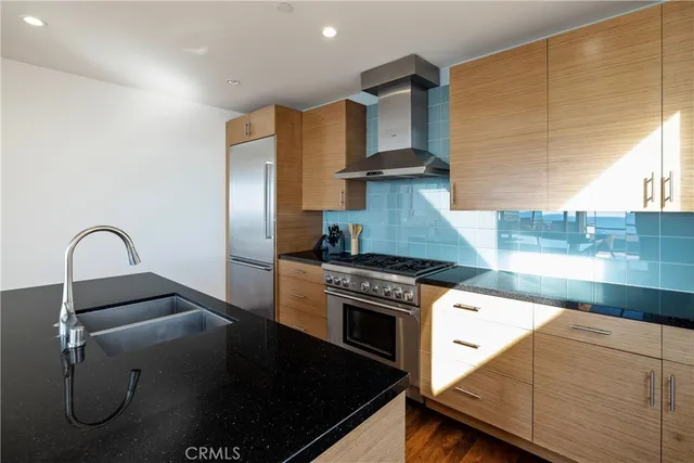 a kitchen with a stove and a refrigerator