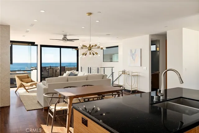 a kitchen with a table chairs stove and kitchen view
