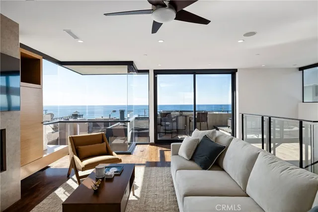 a living room with furniture and a floor to ceiling window