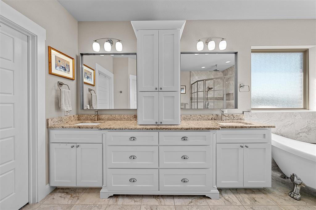 23 Independence Trail Waco, TX 76708 - Photo 18 of 35 Double vanity with white cabinetry, granite countertops, dual sinks, and polished chrome hardware