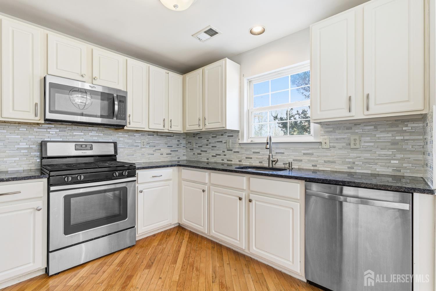 12 Rondell Lane Old Bridge, NJ 08879 - Photo 11 of 34 a kitchen with stainless steel appliances granite countertop a sink a stove a microwave and cabinets