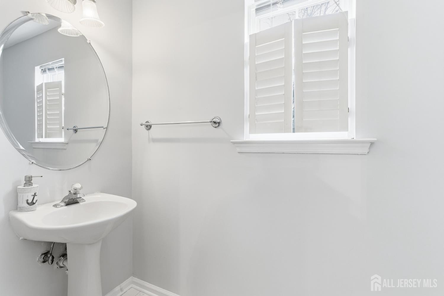 12 Rondell Lane Old Bridge, NJ 08879 - Photo 15 of 34 a bathroom with a sink a mirror and a window
