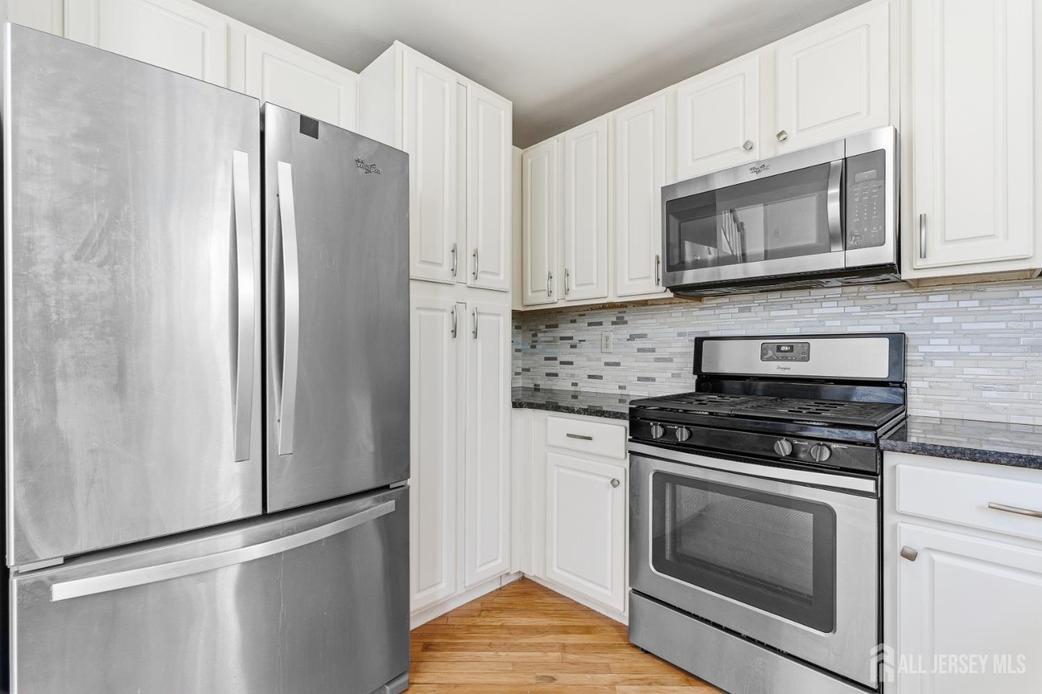 12 Rondell Lane Old Bridge, NJ 08879 - Photo 10 of 34 a kitchen with white cabinets and stainless steel appliances