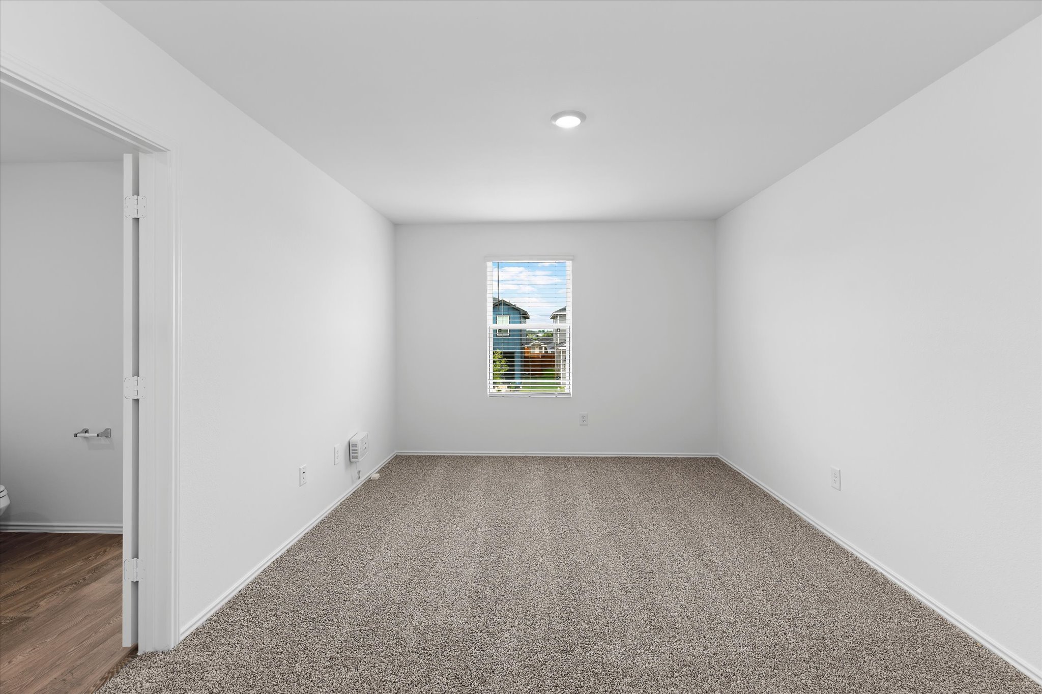 456 Sandringham Loop Kyle, TX 78640 - Photo 17 of 40 A well-lit bedroom provides a comfortable retreat with plush carpeting and natural light.
