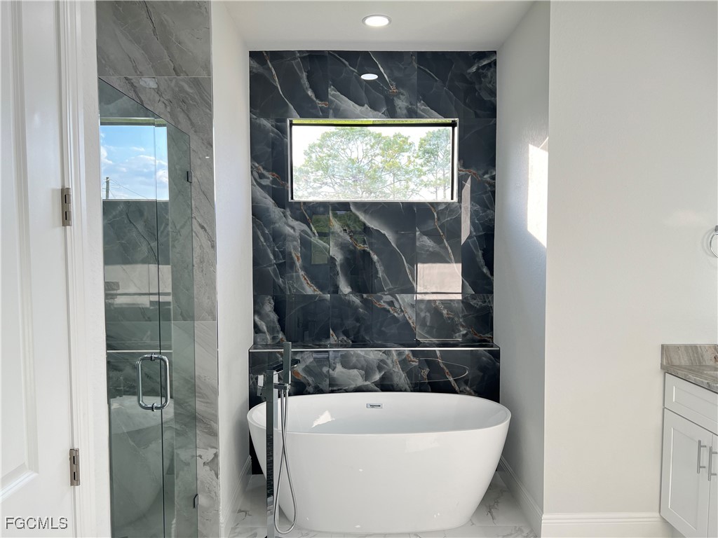 1010 Angelo Avenue Lehigh Acres, FL 33971 - Photo 12 of 34 a view of a bathtub in a bathroom