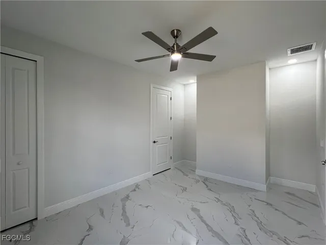 a view of a hallway with a chandelier fan