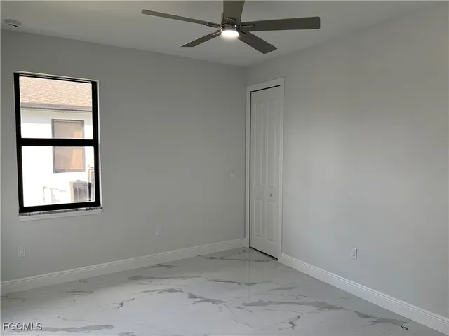 an empty room with a window and painted walls