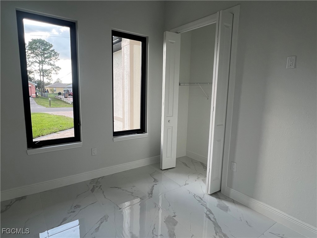 1010 Angelo Avenue Lehigh Acres, FL 33971 - Photo 27 of 34 an empty room that has a window