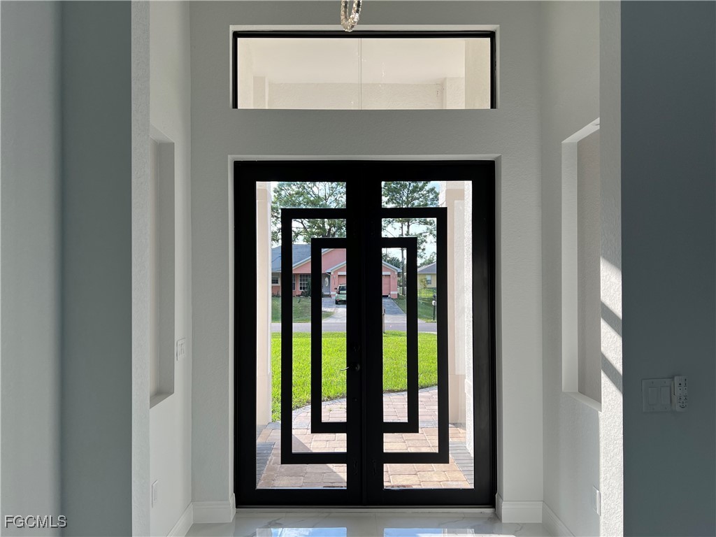 1010 Angelo Avenue Lehigh Acres, FL 33971 - Photo 3 of 34 a front view of a house with a large window