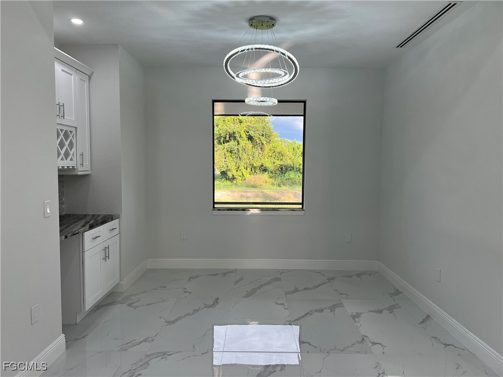 1010 Angelo Avenue Lehigh Acres, FL 33971 - Photo 9 of 34 an empty room with windows