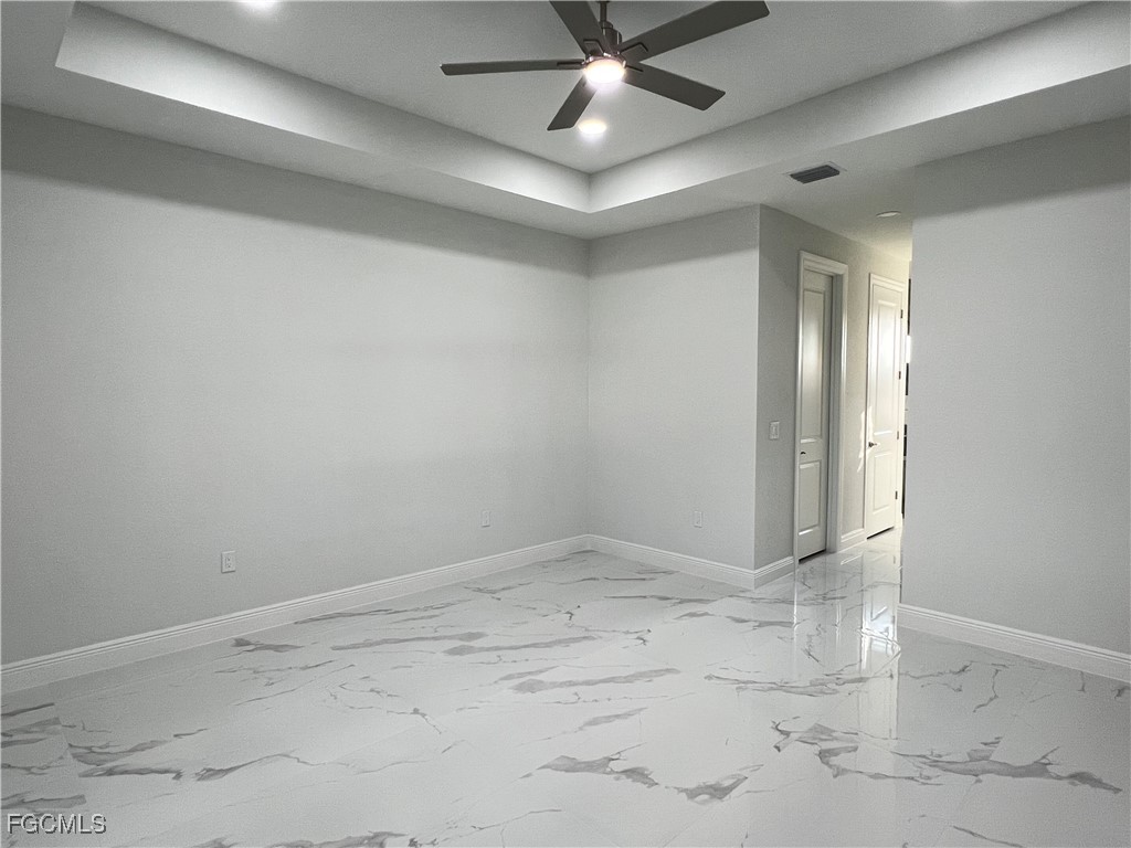 1010 Angelo Avenue Lehigh Acres, FL 33971 - Photo 10 of 34 an empty room with a ceiling fan and window