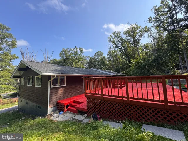 a view of backyard with deck and wooden floor