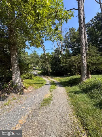a backyard of a house with yard and trampoline