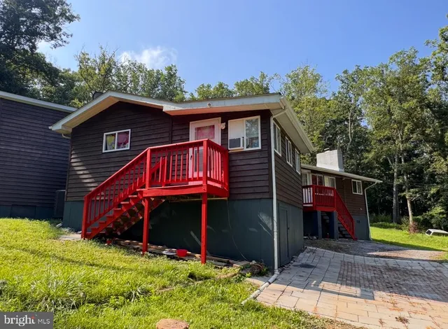 a balcony with wooden floor and outdoor seating