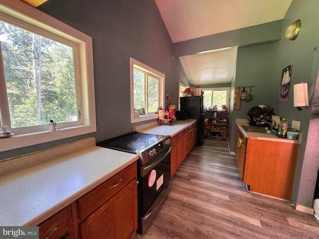 a kitchen with wooden cabinets and sink