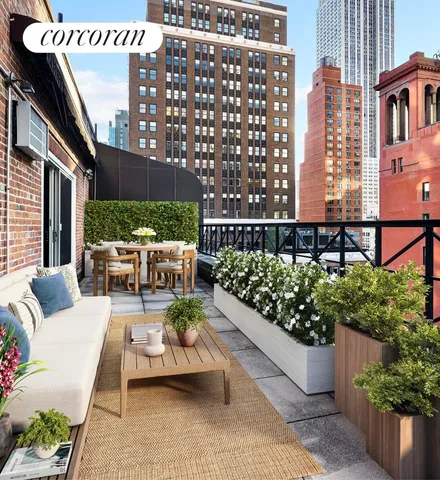a view of a patio with couches table and chairs and potted plants