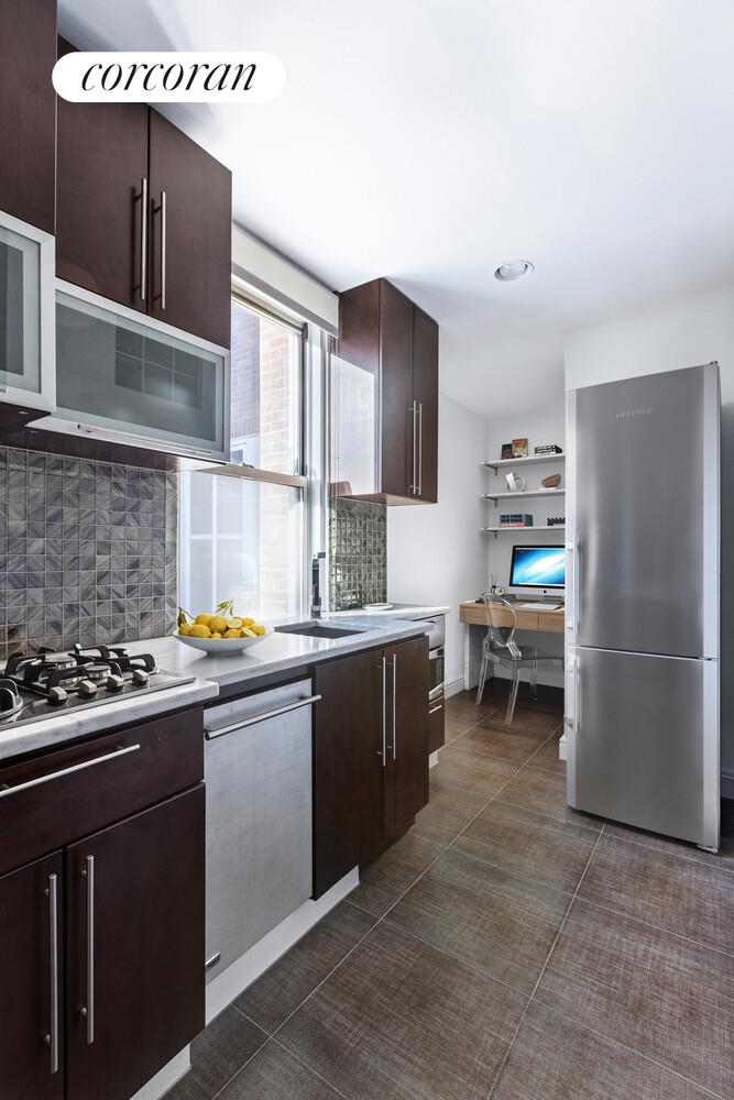 220 Madison Avenue, Unit PHC Manhattan, NY 10016 - Photo 11 of 15 a kitchen with a sink cabinets and appliances