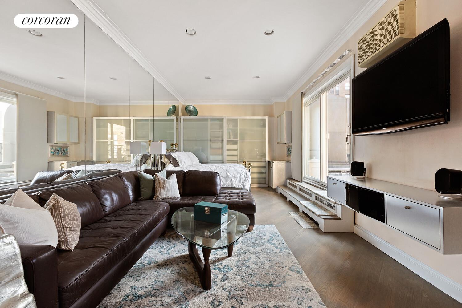 220 Madison Avenue, Unit PHC Manhattan, NY 10016 - Photo 3 of 15 a living room with furniture and a flat screen tv