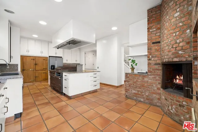 a kitchen with cabinets and a fireplace