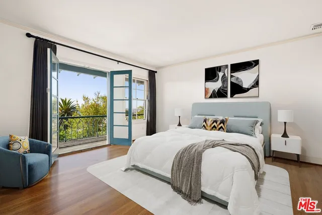 a bedroom with a large bed and a window