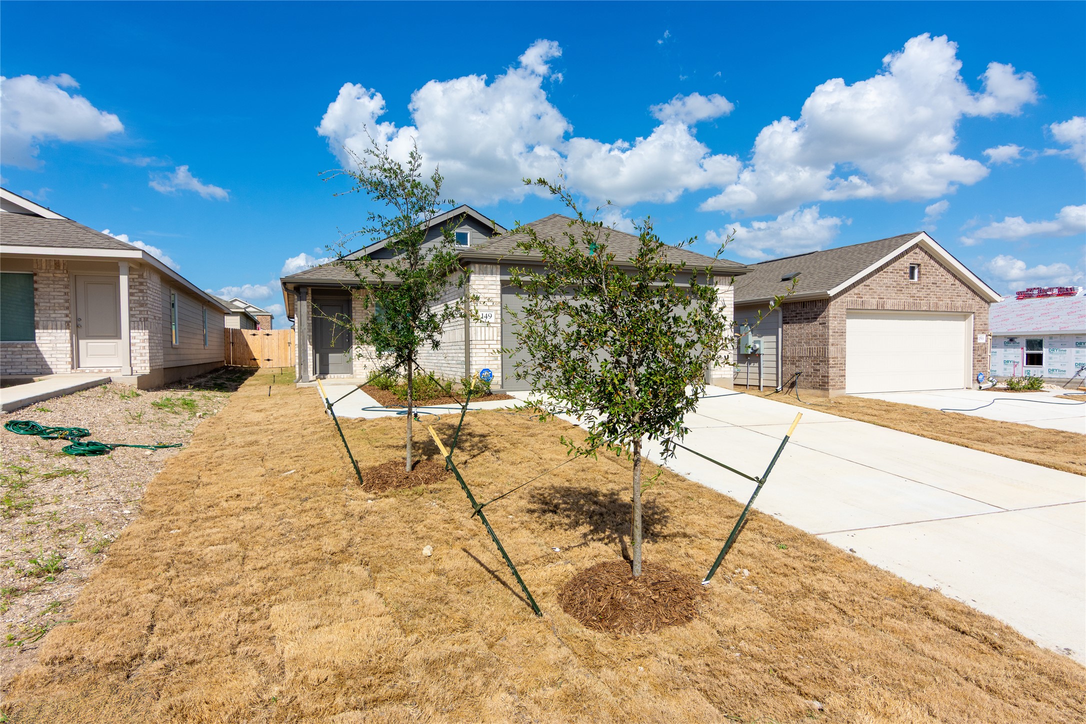 149 Star Packer Lane Jarrell, TX 76537 - Photo 3 of 30 A newly constructed residence boasts a clean exterior and an attached garage, offering modern comfort.