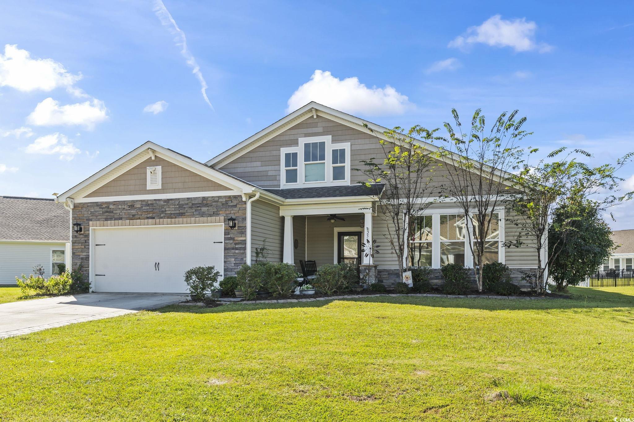 256 Copper Leaf Drive Myrtle Beach, SC 29588 - Photo 1 of 40 Craftsman inspired home with stone siding, a front lawn, concrete driveway, and a porch